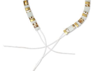 Close-up of two separated ends of a handmade stretch bracelet